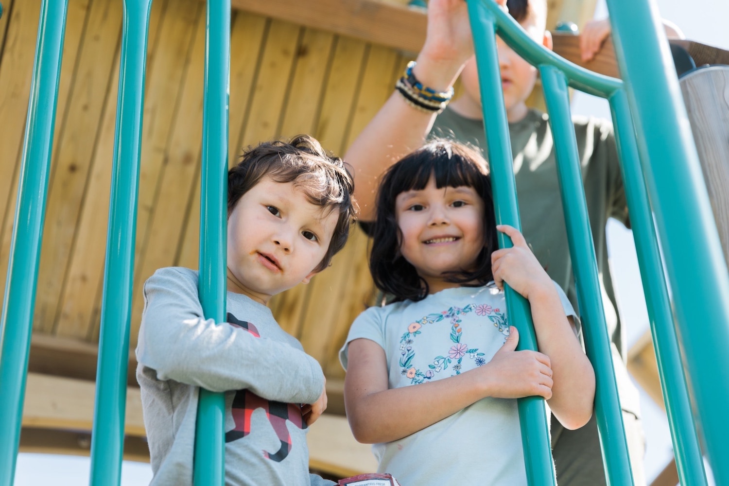 Decorative image - two children on a playground looking at the camera.
